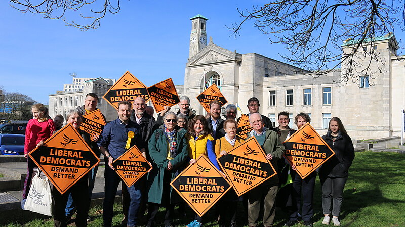 A Group of Liberal Democrats holding signs in front of Southampton Civic Cenre