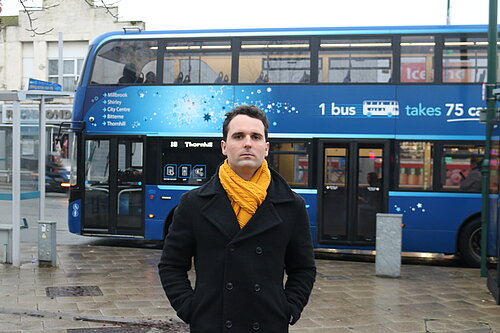 George Percival in front of a bus