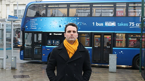 George Percival in front of a bus