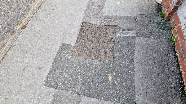 Patchwork tarmac on a pavement