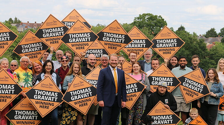 Thomas Gravatt with a crowd of Lib Dems with signs 