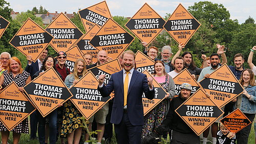 Thomas Gravatt with a group of cheering Lib Dems